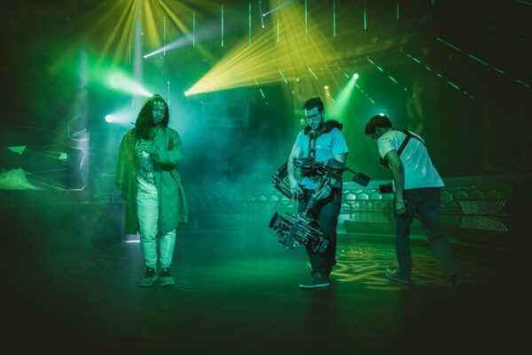A group of people standing in front of lights.