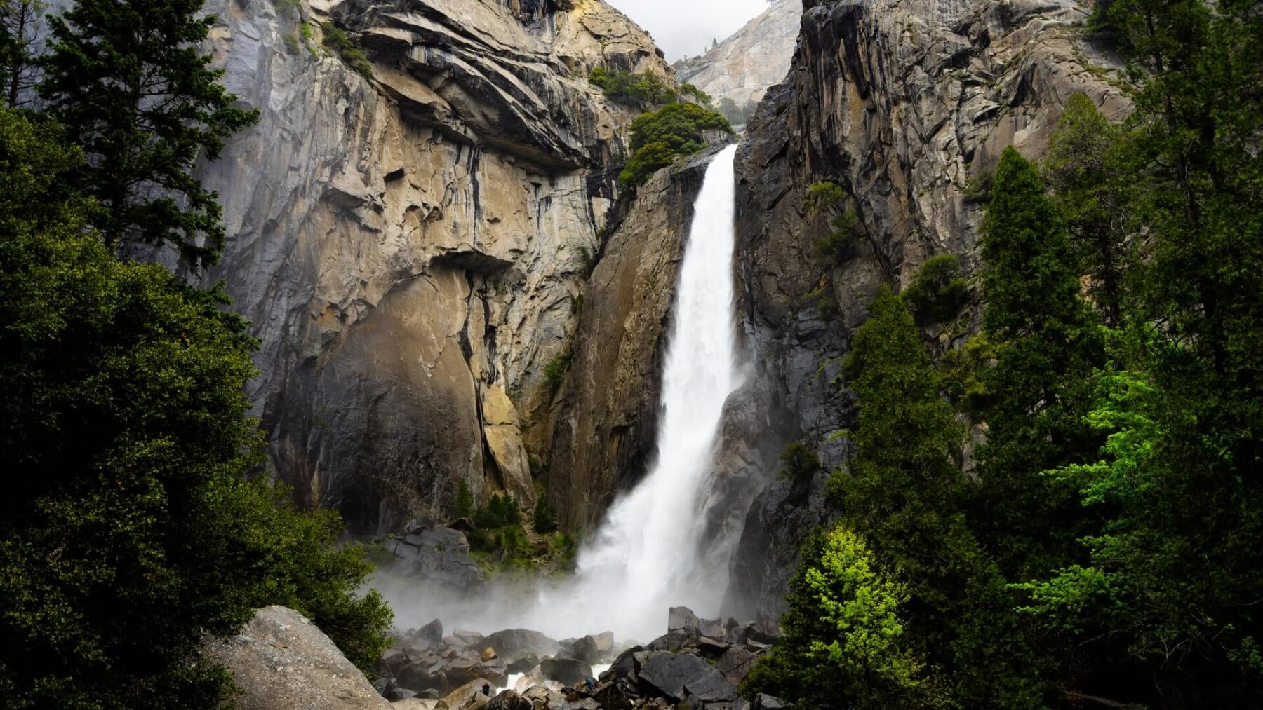 A waterfall is shown in the mountains.
