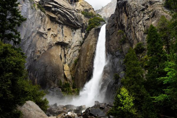 A waterfall is shown in the mountains.