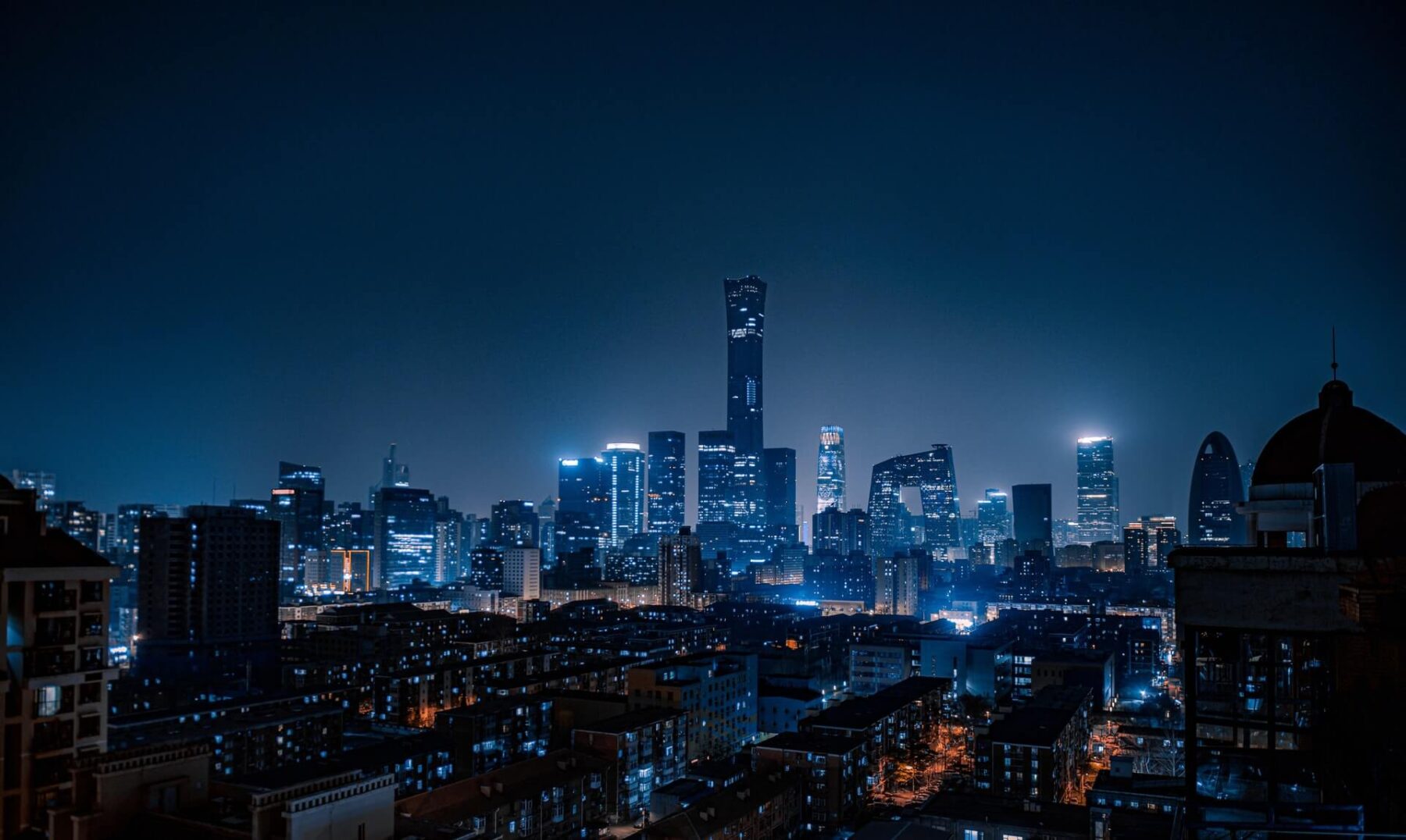 A city skyline at night with lights on.